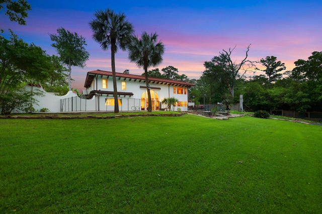 view of back of property at dusk