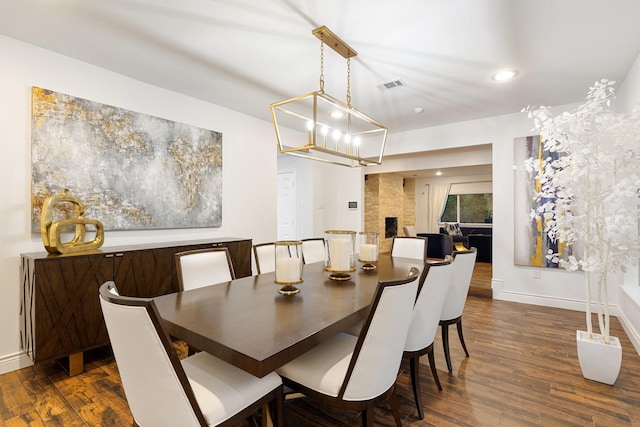 dining room featuring dark wood-style flooring, baseboards, recessed lighting, and a chandelier