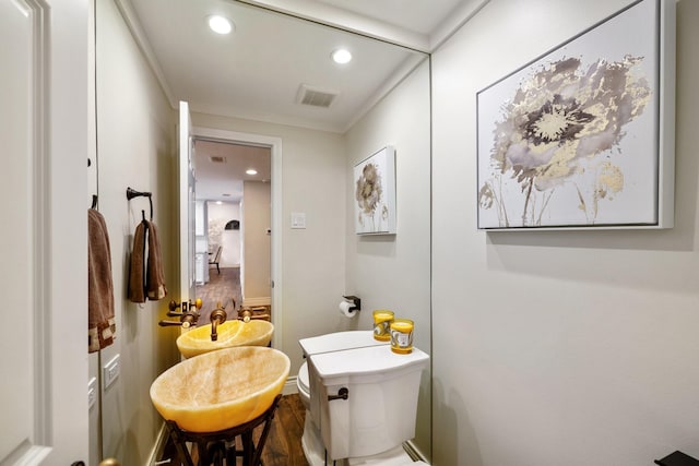 bathroom with recessed lighting and toilet