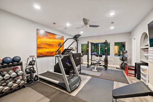 exercise area with recessed lighting, a ceiling fan, baseboards, and wood finished floors