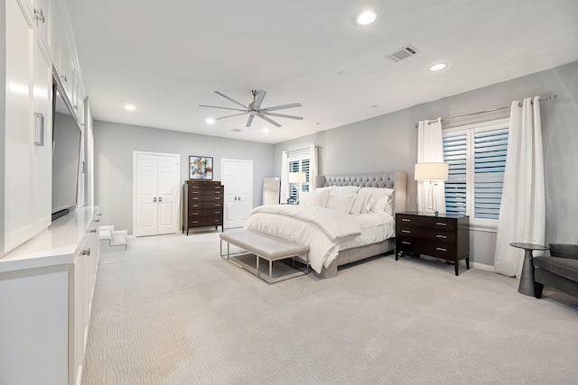 bedroom featuring light colored carpet, recessed lighting, baseboards, and ceiling fan