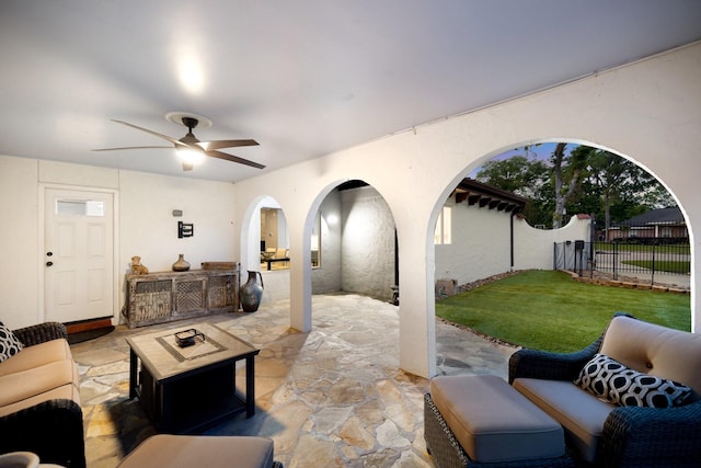 view of patio / terrace featuring an outdoor living space with a fire pit and a ceiling fan