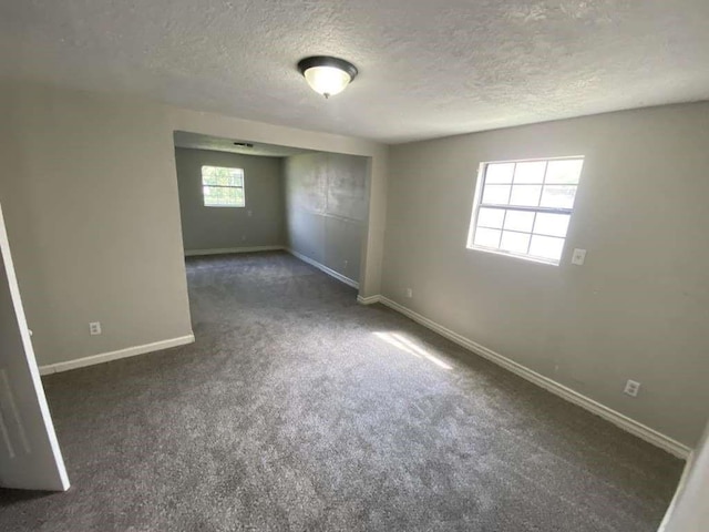 7015 Boyce St, Houston, TX 77020 - carpeted spare room featuring baseboards and a textured ceiling
