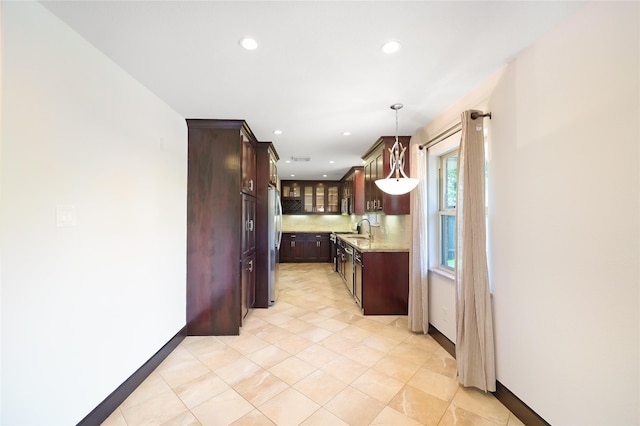 5418 Poinciana Dr, Houston, TX 77092 - kitchen with a sink, freestanding refrigerator, glass insert cabinets, recessed lighting, and baseboards