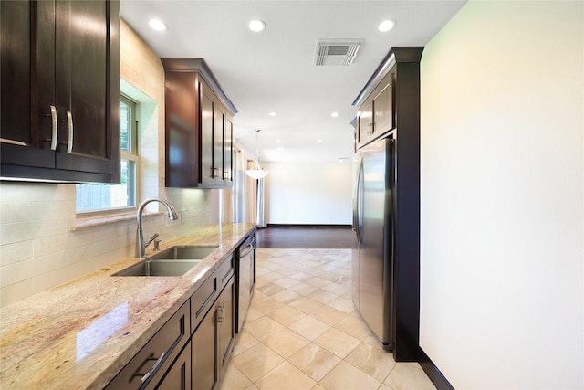 5418 Poinciana Dr, Houston, TX 77092 - kitchen featuring a sink, appliances with stainless steel finishes, decorative backsplash, recessed lighting, and dark brown cabinets