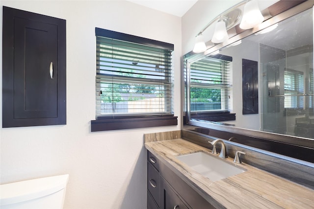 5418 Poinciana Dr, Houston, TX 77092 - bathroom featuring vanity, toilet, plenty of natural light, and a shower with shower door