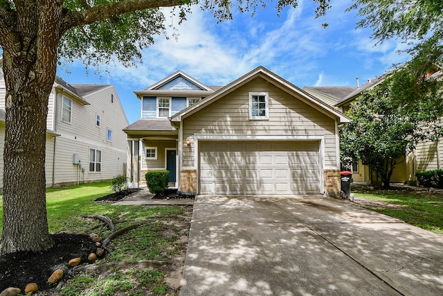 traditional-style house with concrete driveway, brick siding, and a front yard