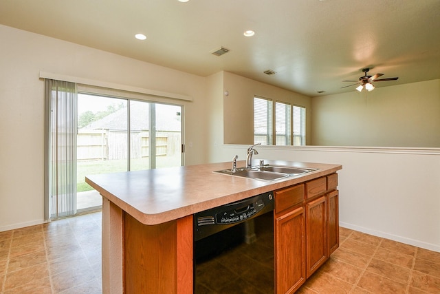 kitchen featuring black dishwasher, a sink, brown cabinetry, light countertops, and a center island with sink