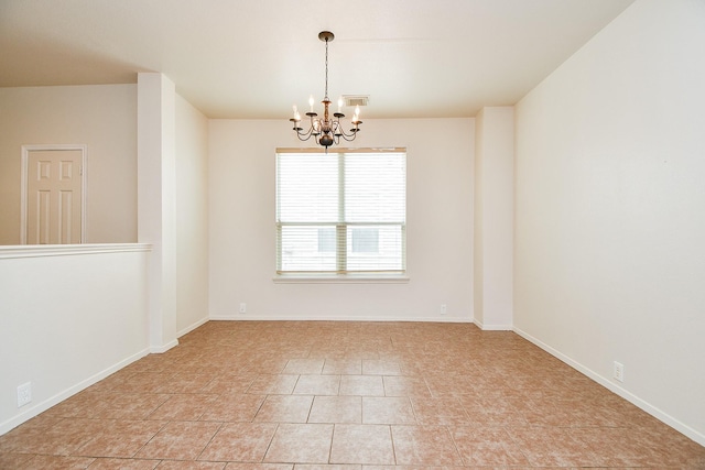 unfurnished room featuring a chandelier and baseboards