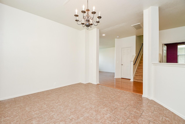 empty room featuring a chandelier, light tile patterned flooring, stairway, recessed lighting, and baseboards