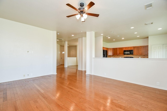 unfurnished living room featuring ceiling fan, light wood finished floors, recessed lighting, and baseboards