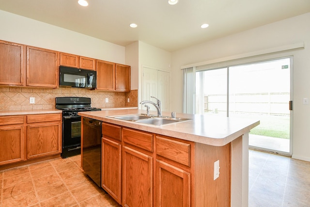kitchen with black appliances, a sink, light countertops, tasteful backsplash, and recessed lighting