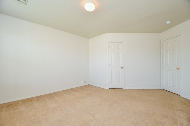 empty room with light carpet, baseboards, and a smoke detector