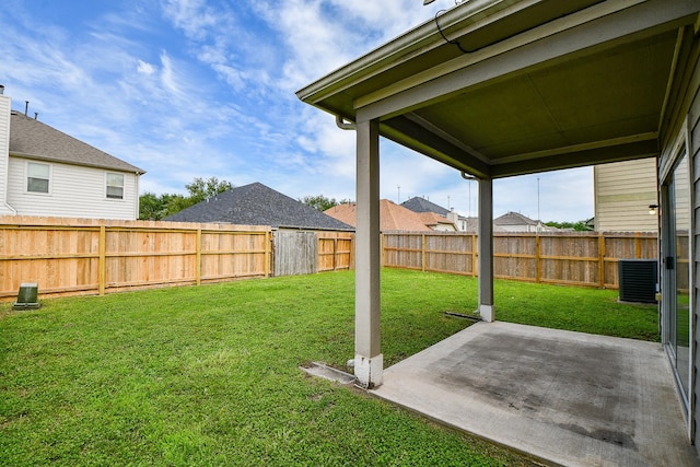 view of yard featuring central air condition unit and a patio area