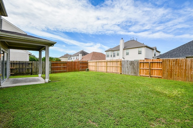 view of yard featuring a patio area and a residential view