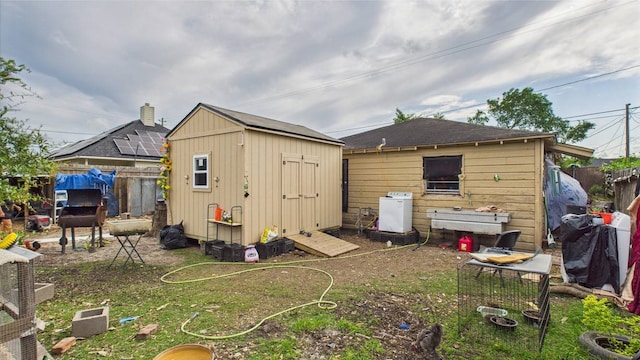 8935 Duane St, Houston, TX 77051 - back of house with a shed, a fenced backyard, and an outbuilding