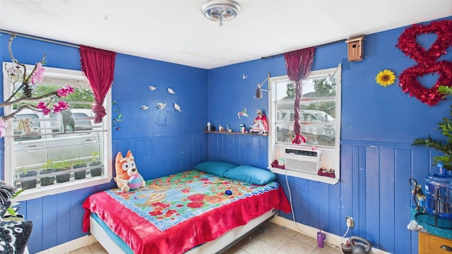 8935 Duane St, Houston, TX 77051 - tiled bedroom featuring a wainscoted wall, cooling unit, and wooden walls