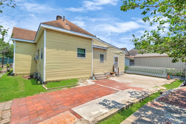 2602 Saltus St, Houston, TX 77003 - rear view of house with a patio area, a lawn, and a chimney