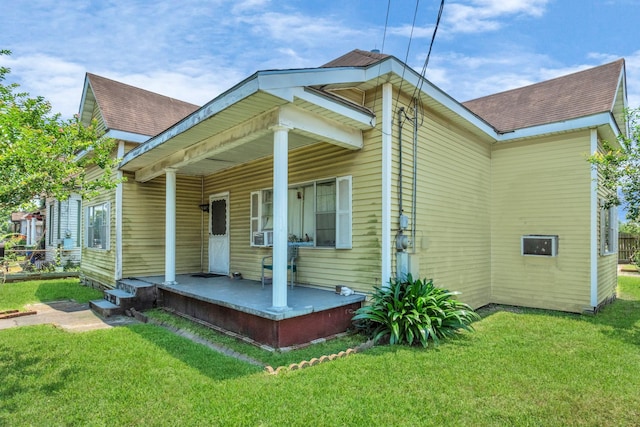 2602 Saltus St, Houston, TX 77003 - back of house featuring covered porch, a yard, and roof with shingles