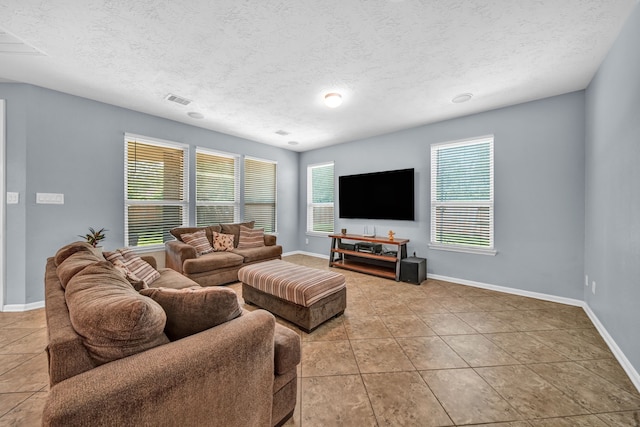 20703 Fawn Timber Trl, Humble, TX 77346 - living area featuring tile patterned flooring, a textured ceiling, and baseboards