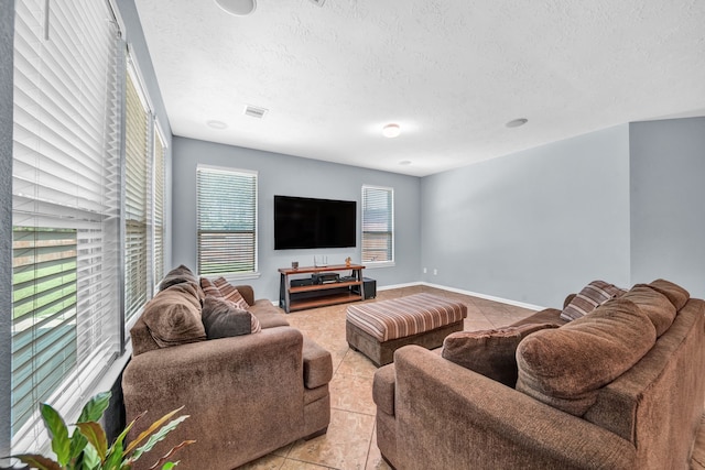20703 Fawn Timber Trl, Humble, TX 77346 - living room with light tile patterned floors and a textured ceiling