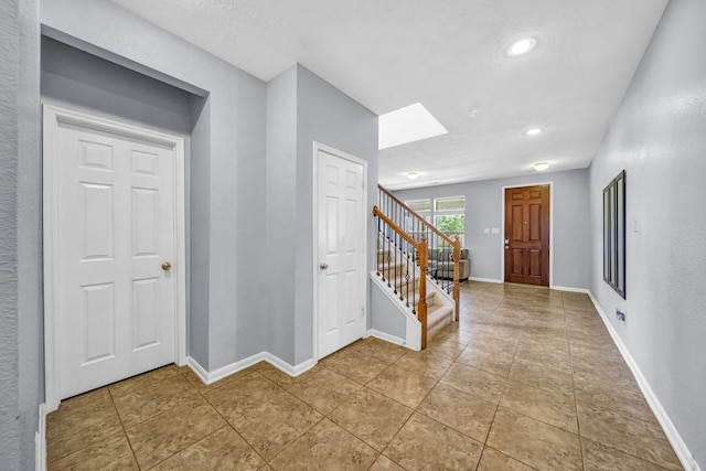 20703 Fawn Timber Trl, Humble, TX 77346 - foyer entrance featuring stairs, a skylight, baseboards, and recessed lighting
