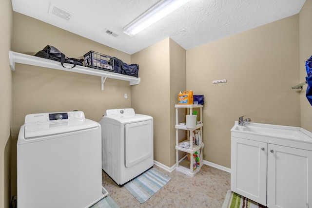 20703 Fawn Timber Trl, Humble, TX 77346 - laundry area with washing machine and dryer, baseboards, and cabinet space