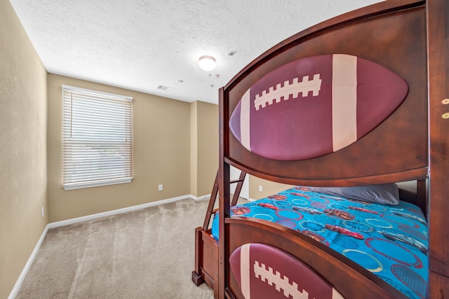 20703 Fawn Timber Trl, Humble, TX 77346 - carpeted bedroom featuring baseboards and a textured ceiling