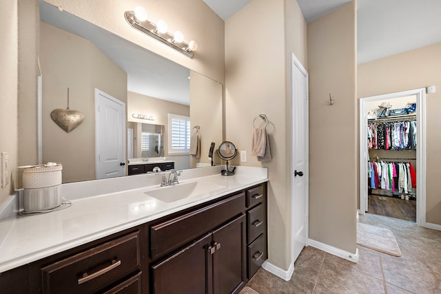 3418 Daniel Falls Ln, Katy, TX 77449 - bathroom with vanity, tile patterned flooring, baseboards, and a spacious closet