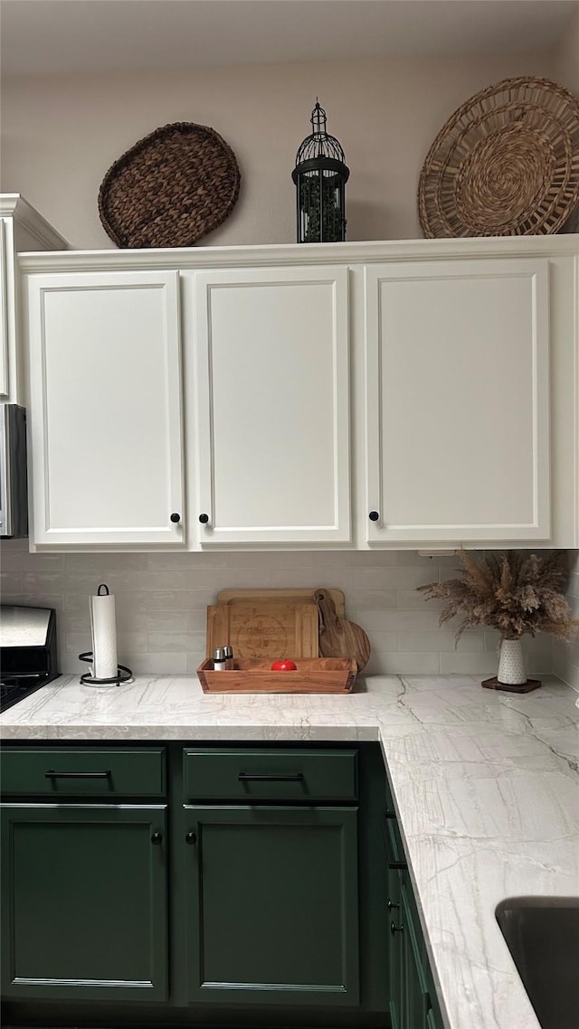 3418 Daniel Falls Ln, Katy, TX 77449 - kitchen with green cabinets, backsplash, and white cabinets