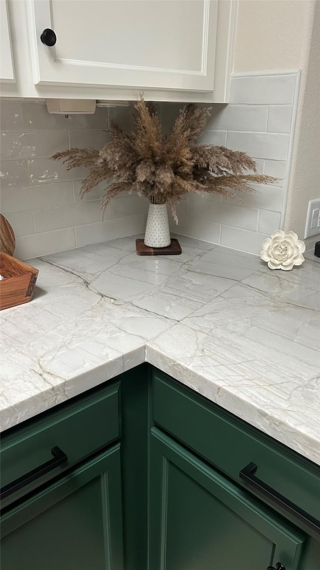 3418 Daniel Falls Ln, Katy, TX 77449 - kitchen view of green cabinets, tasteful backsplash, and white cabinetry