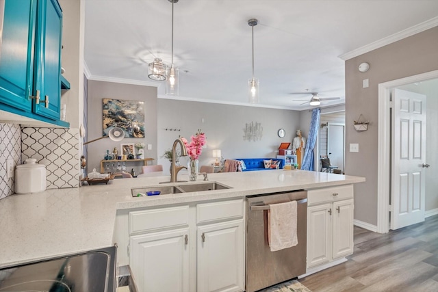 2111 Welch St Unit B201, Houston, TX 77019 - kitchen featuring stainless steel dishwasher, a sink, a peninsula, crown molding, and light countertops
