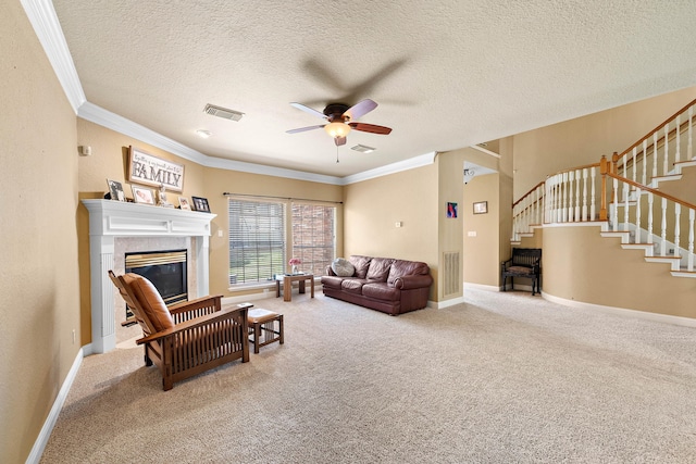 carpeted living room featuring ceiling fan, stairs, crown molding, a fireplace, and baseboards