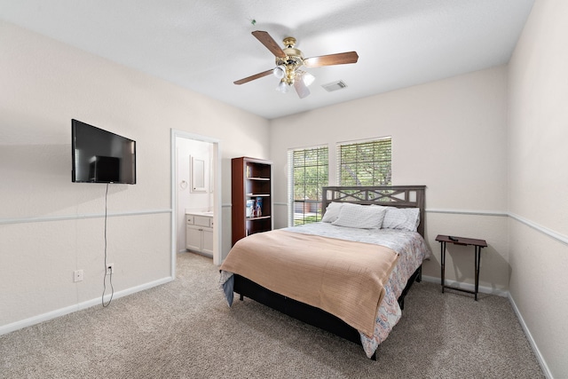 bedroom featuring light carpet, baseboards, and connected bathroom