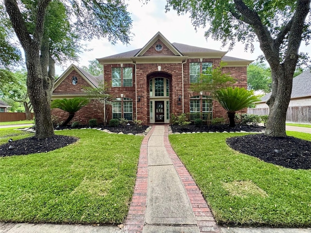 georgian-style home with brick siding