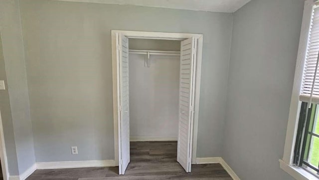 4215 Los Angeles St, Houston, TX 77026 - unfurnished bedroom with dark wood finished floors, a closet, and baseboards