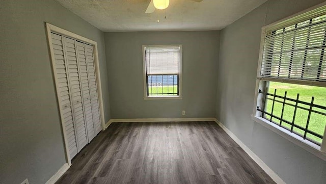 4215 Los Angeles St, Houston, TX 77026 - unfurnished bedroom featuring multiple windows, wood finished floors, baseboards, and a closet