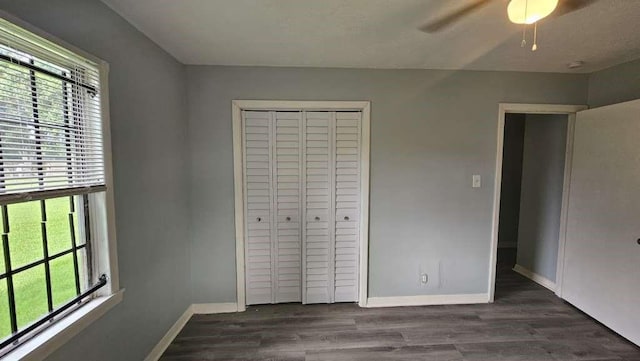 4215 Los Angeles St, Houston, TX 77026 - unfurnished bedroom featuring multiple windows, a closet, baseboards, and wood finished floors