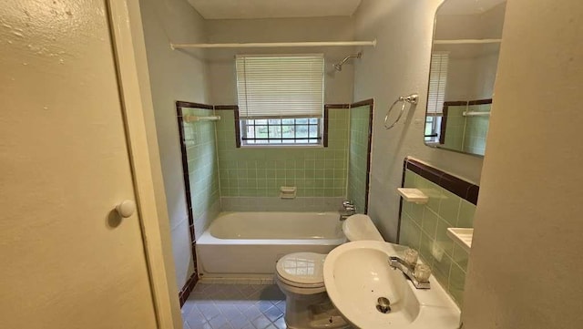 4215 Los Angeles St, Houston, TX 77026 - bathroom featuring a sink, toilet, shower / washtub combination, and tile patterned floors