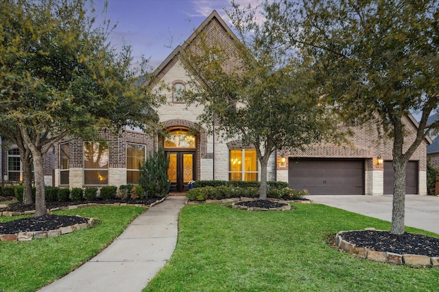 2011 Greenvine Cir, Katy, TX 77494 - view of front facade with french doors, a front lawn, and brick siding