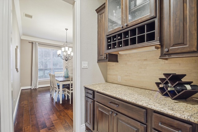 2011 Greenvine Cir, Katy, TX 77494 - kitchen featuring baseboards, decorative backsplash, a chandelier, dark brown cabinets, and crown molding