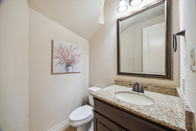 2011 Greenvine Cir, Katy, TX 77494 - half bathroom with vaulted ceiling, vanity, toilet, a textured wall, and a textured ceiling