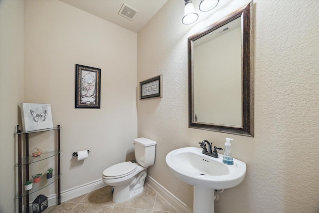 2011 Greenvine Cir, Katy, TX 77494 - bathroom with tile patterned floors, toilet, baseboards, and a sink