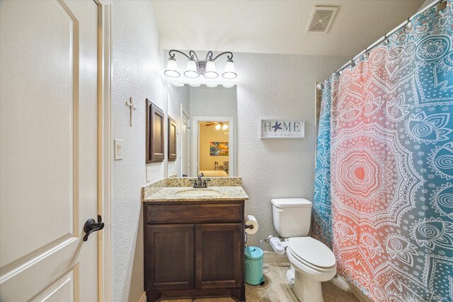 2011 Greenvine Cir, Katy, TX 77494 - bathroom with a textured wall, toilet, vanity, and tile patterned floors