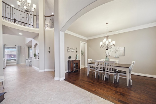 2011 Greenvine Cir, Katy, TX 77494 - dining room featuring a chandelier, arched walkways, ornamental molding, baseboards, and tile patterned floors