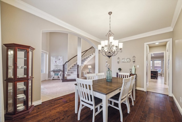 2011 Greenvine Cir, Katy, TX 77494 - dining area with a chandelier, stairway, dark wood-style floors, crown molding, and arched walkways