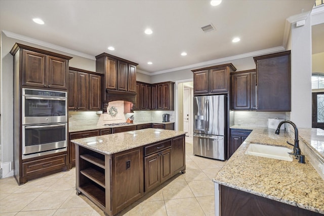 2011 Greenvine Cir, Katy, TX 77494 - kitchen featuring appliances with stainless steel finishes, a sink, open shelves, light stone counters, and dark brown cabinets