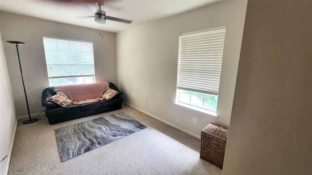 sitting room with carpet flooring, ceiling fan, and baseboards