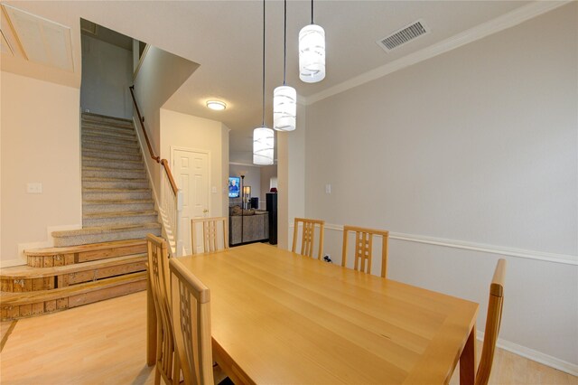 1635 Pebble Banks, Pasadena, TX 77586 - dining space with wood finished floors, stairs, crown molding, and baseboards