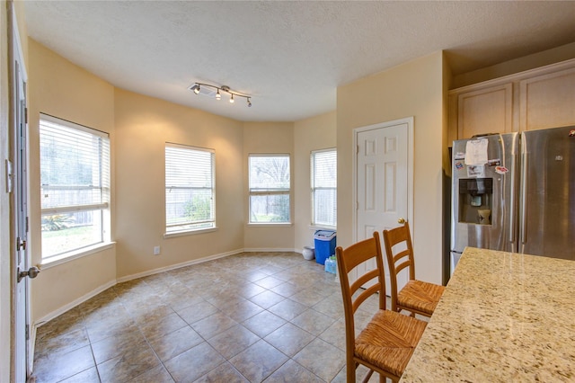 1635 Pebble Banks, Pasadena, TX 77586 - unfurnished dining area featuring light tile patterned flooring, a textured ceiling, and baseboards